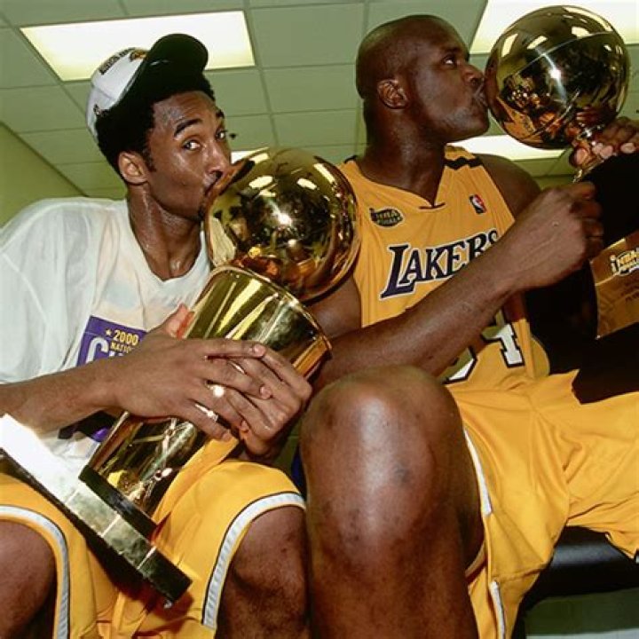 Start: Kobe, who is one of the greatest basketball players of all time, played his entire NBA career for the Los Angeles Lakers; the athlete was drafted out of high school and made his professional debut in 1996; pictured with Jerry West and Del Harris